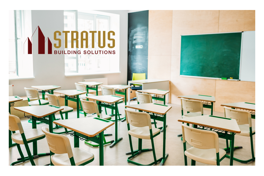 School classroom with desks and a chalkboard with the Stratus Logo