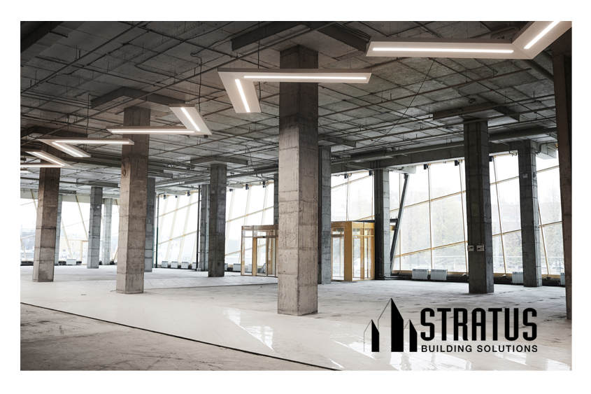 Large Office Interior Under Construction with Open Beams and Concrete Floors in Need of Cleaning